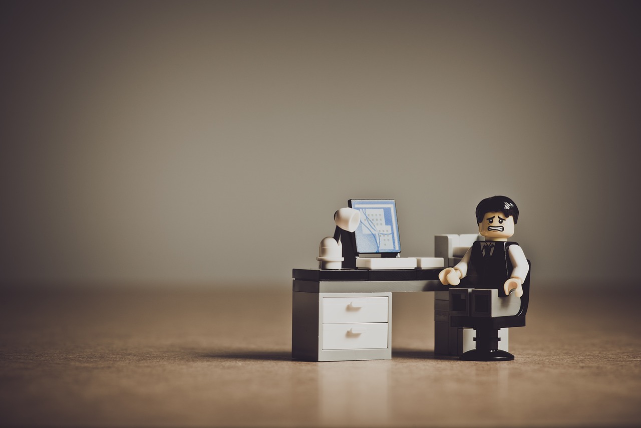 A nervous lego man at a desk